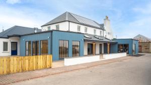 a house with a blue and white facade at Shore Hotel in Balintore