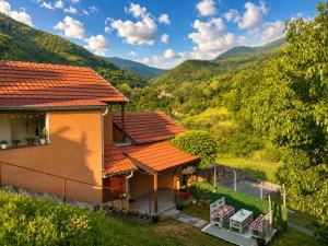 a house with a view of the mountains at Apartmani Stankovic in Crni Vrh