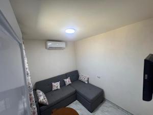 a small living room with a couch in a room at Studio 3rd Floor Blumar one bedroom in El Alamein