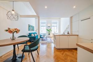 a kitchen and living room with a table and chairs at Gem Stone City Center in Olomouc