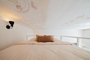 a bedroom with a bed with a ceiling with flowers at Gem Stone City Center in Olomouc
