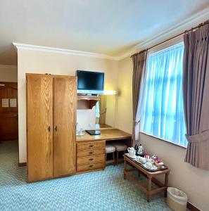 a hotel room with a desk and a window at Rathbaun Hotel in Lisdoonvarna
