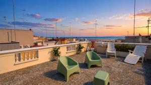 a patio with chairs and tables on a roof at Dimora IL TULIPANO BIANCO in Massafra