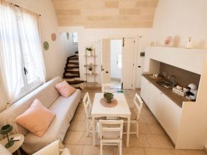 a living room with a couch and a table at Dimora IL TULIPANO BIANCO in Massafra +11 photos