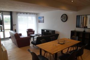 a living room with a table and chairs at Ty Le Gall in Plouescat