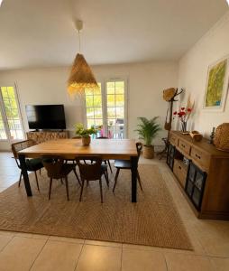 a dining room with a wooden table and chairs at Les Terrasses du Vercors in Beauregard-Baret