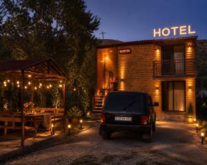 a truck parked in front of a hotel at night at Syuzn Resort in Goris