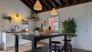 a kitchen with a large black island in the middle at Villa Capelinhos in Capelo
