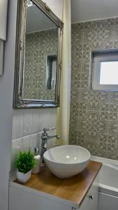 a bathroom with a white sink and a mirror at Studio Rodica in Zalău