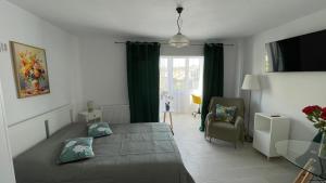 a bedroom with a bed and a table and a window at Studio Rodica in Zalău