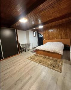 a bedroom with a bed and a table and a chalkboard at Happy Home in Bucharest