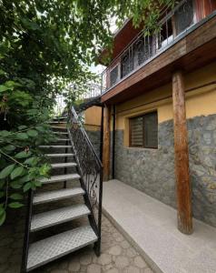 a staircase leading up to a building with a balcony at Happy Home in Bucharest