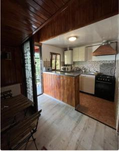 a kitchen with wooden floors and a counter top at Happy Home in Bucharest