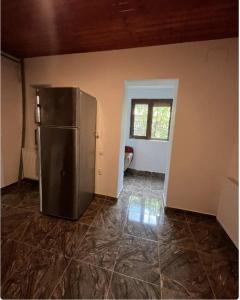 a kitchen with a stainless steel refrigerator in a room at Happy Home in Bucharest
