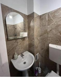 a bathroom with a sink and a mirror at Happy Home in Bucharest +25 photos