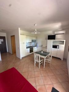 a kitchen and living room with a table and chairs at La CASA DI LUDO in Bernalda +12 photos
