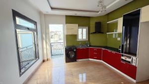a kitchen with a washing machine in a room with a window at David Home in Danang +2 photos