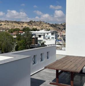 a wooden bench sitting on top of a balcony at Sea View Penthouse in Larnaca