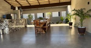 a dining room with a table and chairs in a building at Residência Araguaia in Aruanã