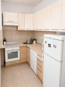 a kitchen with white appliances and a white refrigerator at Apartman Centar Agrokop in Trebinje