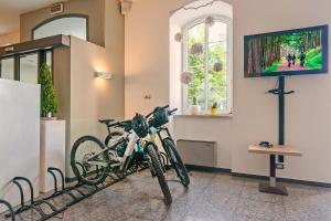 a pair of bikes parked in a room with a tv at Hotel Liberty in Levico Terme