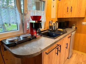 a kitchen with a coffee maker on a counter at Zielone okiennice in Chobie +17 photos