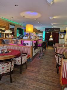 a restaurant with tables and chairs and a counter at Gästehaus La Puccia in Mittenwald