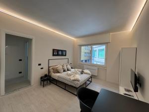 a bedroom with a bed and a window and a table at Mono Chic by PortofinoVacanze in Rapallo