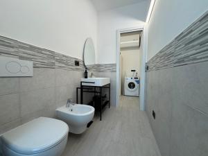 a bathroom with a toilet and a sink and a washing machine at Mono Chic by PortofinoVacanze in Rapallo +16 photos