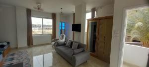 a living room with a couch and a television at Morsy Palace in Luxor