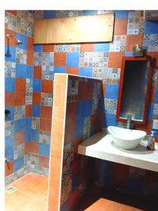 a bathroom with a sink and a mirror at Casa Tania in Mazunte +5 photos