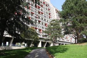 a large apartment building with a path in front of it at Le Corbusier Expérience in Firminy