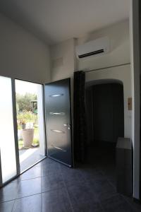a glass door in a room with a window at Chez Sylvain in Carcès