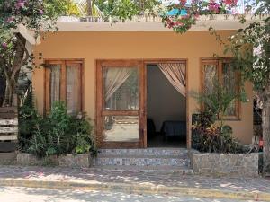 a front door of a house with flowers at Casa Tania in Mazunte