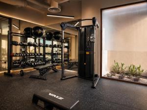 a room with a gym with lots of equipment at Locanda Homes by Jareed لوكاندا هومز باي جريد in Riyadh