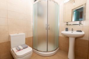 a bathroom with a shower and a toilet and a sink at Centrum Rooms in Kallithea Halkidikis +83 photos
