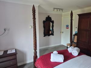 a bedroom with a bed with towels on it at Remus B&B in Lochgelly