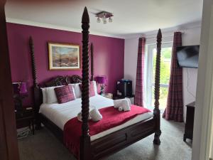 a bedroom with a bed with purple walls at Remus B&B in Lochgelly