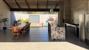 a kitchen and dining room with a table and chairs at Residência Araguaia in Aruanã
