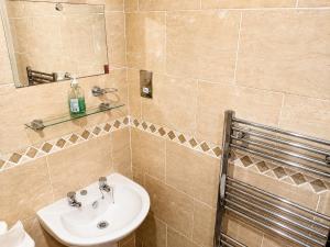 a bathroom with a sink and a mirror at Endeavour Cottage Whitby Quiet Old Yard Fishermans Cottage in Whitby +31 photos
