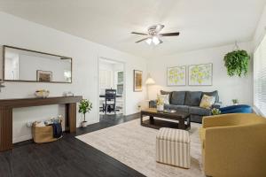 a living room with a couch and a mirror at Italian Cottage 2B 1B Duplex KING Pet Friendly in Richardson +4 photos
