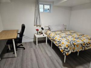 a bedroom with a bed and a desk and a desk at CozyHaven in St. Catharines