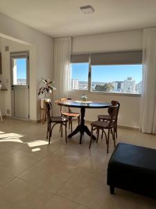 a living room with a table and chairs with a view at Refugio Centro in Puerto Madryn