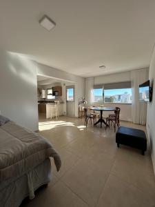 a bedroom with a bed and a table with chairs at Refugio Centro in Puerto Madryn +2 photos