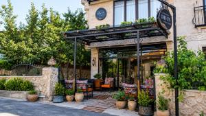 a restaurant with a patio with chairs and plants at Cappadocia Divin House in Göreme