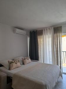 a bedroom with a large bed and a window at Cannes à Pied in Cannes