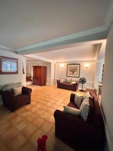 a large living room with two couches at Serenity Garden Escape in Port-of-Spain