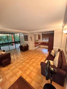 a large living room with a couch and chairs at Serenity Garden Escape in Port-of-Spain +18 photos