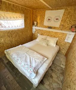 a small bedroom with a bed in a tiny house at Konak Mara- Komovi in Andrijevica