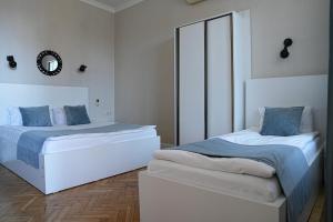 a bedroom with two beds and a mirror at Hotel Ticiani 15 in Kutaisi